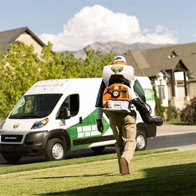 Man applying mosquito spray in a residential setting